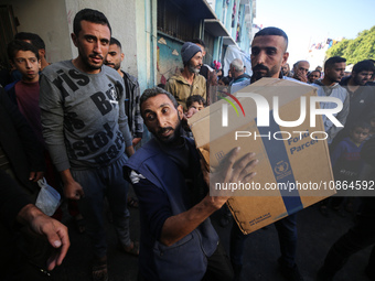 Displaced Palestinians are taking shelter in a UNRWA-affiliated Deir al-Balah school after fleeing their homes due to Israeli strikes, amid...