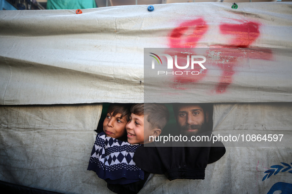 Displaced Palestinians are taking shelter in a UNRWA-affiliated Deir al-Balah school after fleeing their homes due to Israeli strikes, amid...