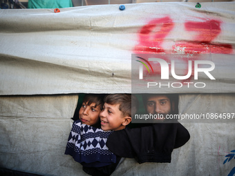 Displaced Palestinians are taking shelter in a UNRWA-affiliated Deir al-Balah school after fleeing their homes due to Israeli strikes, amid...