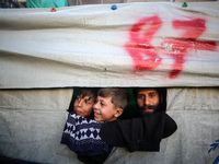 Displaced Palestinians are taking shelter in a UNRWA-affiliated Deir al-Balah school after fleeing their homes due to Israeli strikes, amid...