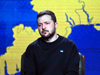 Ukrainian President Volodymyr Zelensky is listening to questions from journalists during his year-end press conference in Kyiv, Ukraine, on...