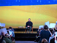 Ukrainian President Volodymyr Zelensky is listening to questions from journalists during his year-end press conference in Kyiv, Ukraine, on...