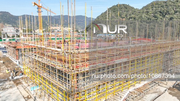 Workers are braving the cold at the construction site of the second phase of the Fuxi Street project in Moganshan town, Deqing County, Huzho...