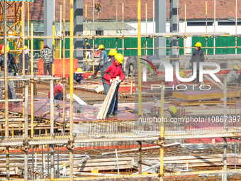 Workers are braving the cold at the construction site of the second phase of the Fuxi Street project in Moganshan town, Deqing County, Huzho...