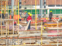 Workers are braving the cold at the construction site of the second phase of the Fuxi Street project in Moganshan town, Deqing County, Huzho...