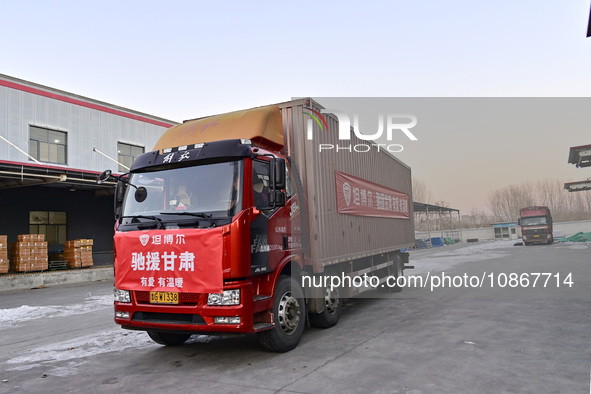 Vehicles are being loaded with supplies for earthquake relief in Jishishan County at a down jacket manufacturer in Qingzhou, Shandong Provin...