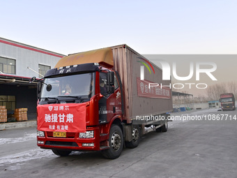 Vehicles are being loaded with supplies for earthquake relief in Jishishan County at a down jacket manufacturer in Qingzhou, Shandong Provin...