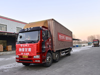 Vehicles are being loaded with supplies for earthquake relief in Jishishan County at a down jacket manufacturer in Qingzhou, Shandong Provin...