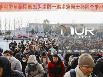 Candidates for the master's degree entrance examination are lining up to enter the test center at Huaiyin Normal University in Huai'an, Chin...