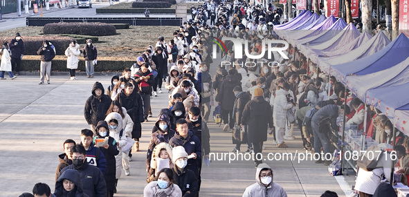 Candidates for the master's degree entrance examination are lining up to enter the test center at Huaiyin Normal University in Huai'an, Chin...