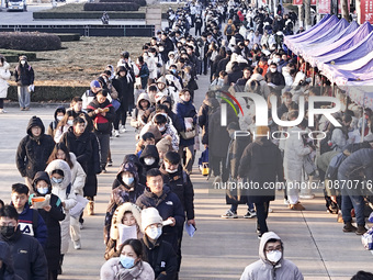 Candidates for the master's degree entrance examination are lining up to enter the test center at Huaiyin Normal University in Huai'an, Chin...