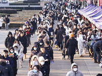 Candidates for the master's degree entrance examination are lining up to enter the test center at Huaiyin Normal University in Huai'an, Chin...