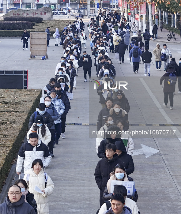 Candidates for the master's degree entrance examination are lining up to enter the test center at Huaiyin Normal University in Huai'an, Chin...