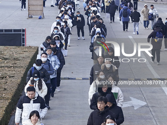 Candidates for the master's degree entrance examination are lining up to enter the test center at Huaiyin Normal University in Huai'an, Chin...