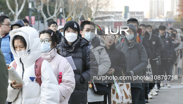 Candidates for the master's degree entrance examination are lining up to enter the test center at Huaiyin Normal University in Huai'an, Chin...