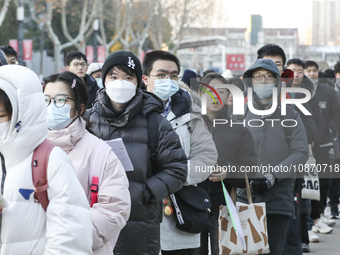 Candidates for the master's degree entrance examination are lining up to enter the test center at Huaiyin Normal University in Huai'an, Chin...