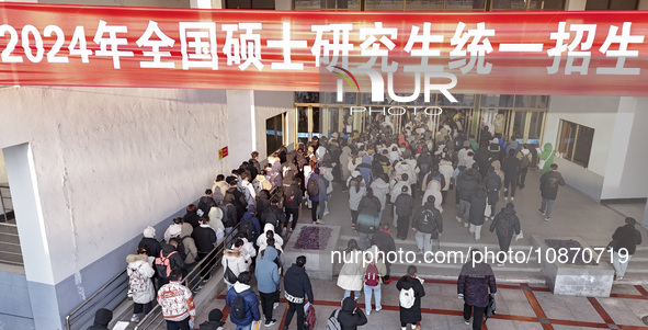 Candidates for the master's degree entrance examination are lining up to enter the test center at Huaiyin Normal University in Huai'an, Chin...