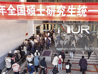 Candidates for the master's degree entrance examination are lining up to enter the test center at Huaiyin Normal University in Huai'an, Chin...