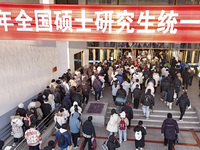 Candidates for the master's degree entrance examination are lining up to enter the test center at Huaiyin Normal University in Huai'an, Chin...