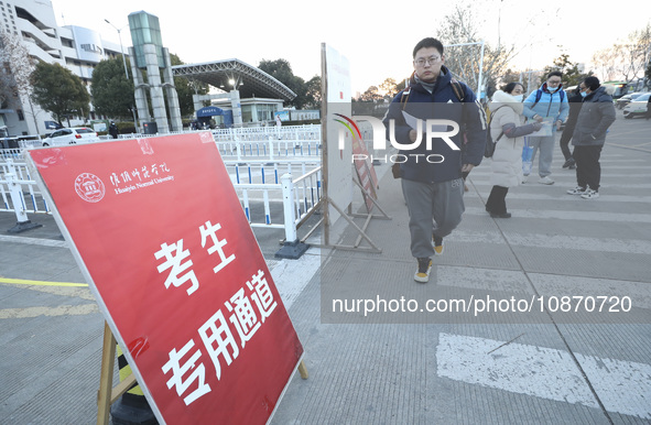 Candidates for the master's degree entrance examination are lining up to enter the test center at Huaiyin Normal University in Huai'an, Chin...