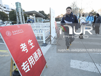 Candidates for the master's degree entrance examination are lining up to enter the test center at Huaiyin Normal University in Huai'an, Chin...