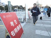 Candidates for the master's degree entrance examination are lining up to enter the test center at Huaiyin Normal University in Huai'an, Chin...