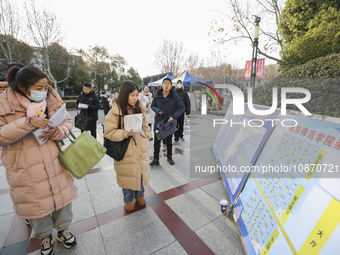 Candidates for the master's degree entrance examination are lining up to enter the test center at Huaiyin Normal University in Huai'an, Chin...