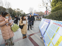 Candidates for the master's degree entrance examination are lining up to enter the test center at Huaiyin Normal University in Huai'an, Chin...