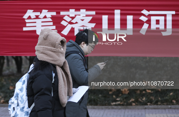 Candidates for the master's degree entrance examination are lining up to enter the test center at Huaiyin Normal University in Huai'an, Chin...