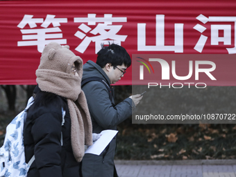 Candidates for the master's degree entrance examination are lining up to enter the test center at Huaiyin Normal University in Huai'an, Chin...