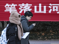 Candidates for the master's degree entrance examination are lining up to enter the test center at Huaiyin Normal University in Huai'an, Chin...