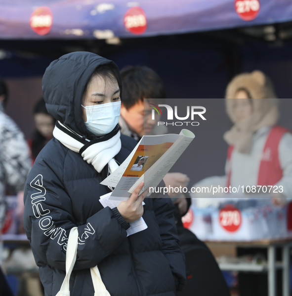 Candidates for the master's degree entrance examination are lining up to enter the test center at Huaiyin Normal University in Huai'an, Chin...