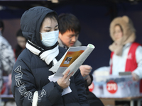 Candidates for the master's degree entrance examination are lining up to enter the test center at Huaiyin Normal University in Huai'an, Chin...