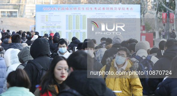 Candidates for the master's degree entrance examination are lining up to enter the test center at Huaiyin Normal University in Huai'an, Chin...