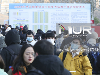 Candidates for the master's degree entrance examination are lining up to enter the test center at Huaiyin Normal University in Huai'an, Chin...