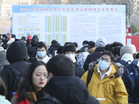 Candidates for the master's degree entrance examination are lining up to enter the test center at Huaiyin Normal University in Huai'an, Chin...