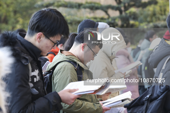 Candidates for the master's degree entrance examination are lining up to enter the test center at Huaiyin Normal University in Huai'an, Chin...