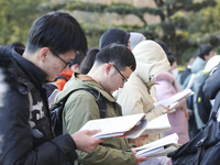 Candidates for the master's degree entrance examination are lining up to enter the test center at Huaiyin Normal University in Huai'an, Chin...