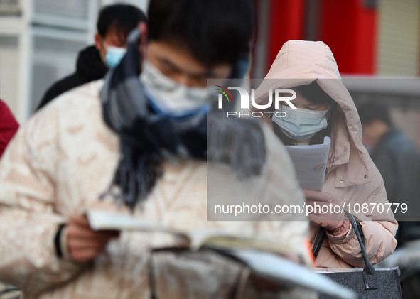 Candidates are preparing to enter the entrance exam for postgraduate students at the No. 15 Middle School exam center in Fuyang, China, on D...