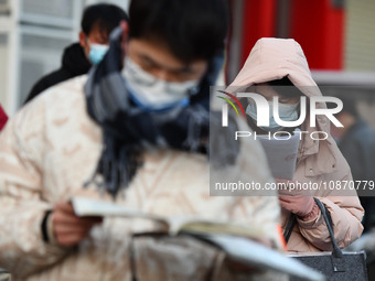 Candidates are preparing to enter the entrance exam for postgraduate students at the No. 15 Middle School exam center in Fuyang, China, on D...