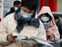 Candidates are preparing to enter the entrance exam for postgraduate students at the No. 15 Middle School exam center in Fuyang, China, on D...