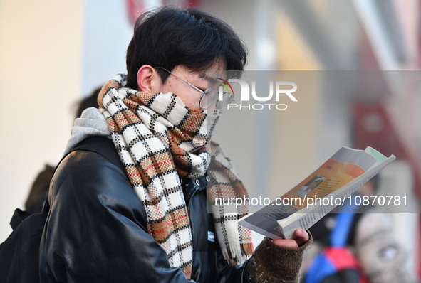 Candidates are preparing to enter the entrance exam for postgraduate students at the No. 15 Middle School exam center in Fuyang, China, on D...