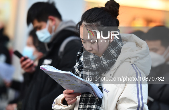 Candidates are preparing to enter the entrance exam for postgraduate students at the No. 15 Middle School exam center in Fuyang, China, on D...