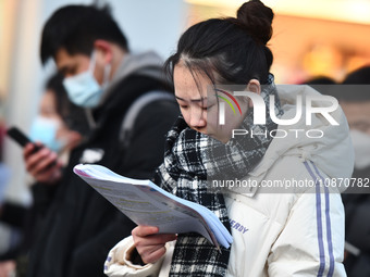 Candidates are preparing to enter the entrance exam for postgraduate students at the No. 15 Middle School exam center in Fuyang, China, on D...