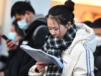 Candidates are preparing to enter the entrance exam for postgraduate students at the No. 15 Middle School exam center in Fuyang, China, on D...