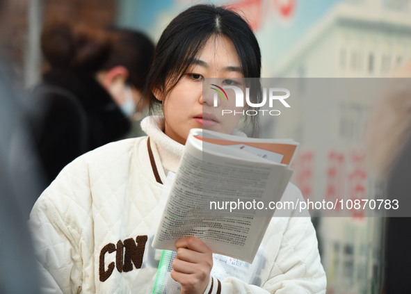 Candidates are preparing to enter the entrance exam for postgraduate students at the No. 15 Middle School exam center in Fuyang, China, on D...