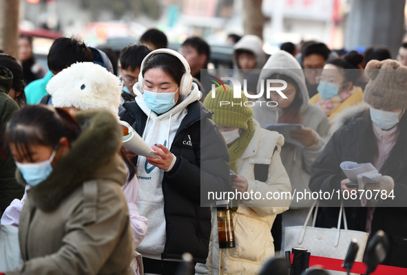 Candidates are preparing to enter the entrance exam for postgraduate students at the No. 15 Middle School exam center in Fuyang, China, on D...