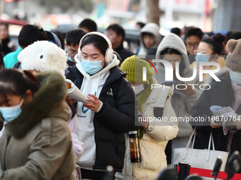 Candidates are preparing to enter the entrance exam for postgraduate students at the No. 15 Middle School exam center in Fuyang, China, on D...