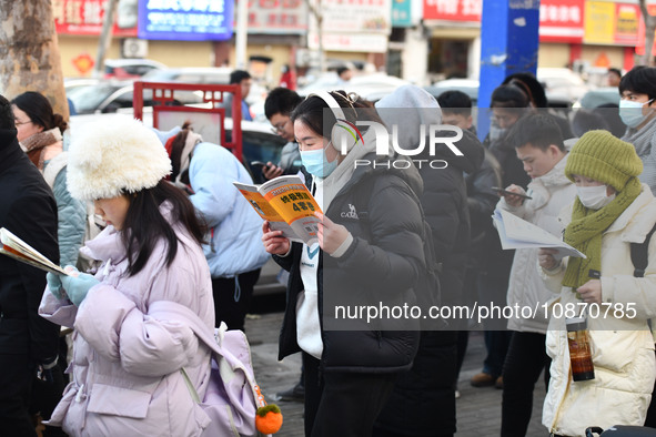 Candidates are preparing to enter the entrance exam for postgraduate students at the No. 15 Middle School exam center in Fuyang, China, on D...