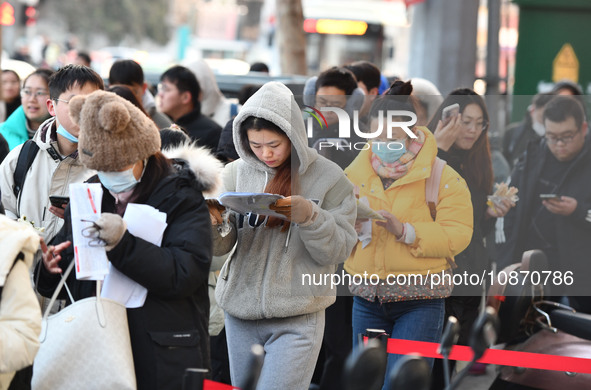 Candidates are preparing to enter the entrance exam for postgraduate students at the No. 15 Middle School exam center in Fuyang, China, on D...